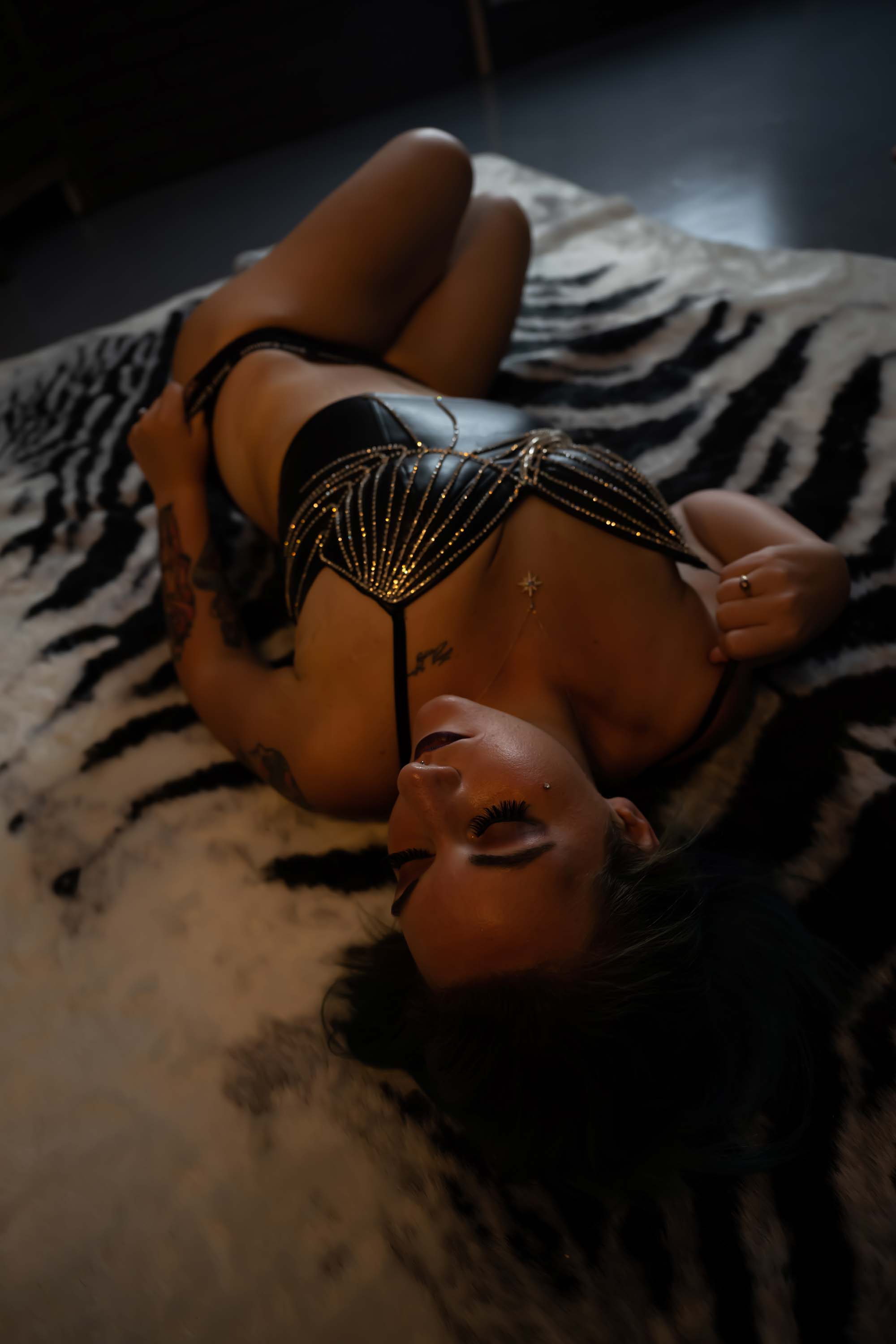 woman laying on zebra rug in lingerie